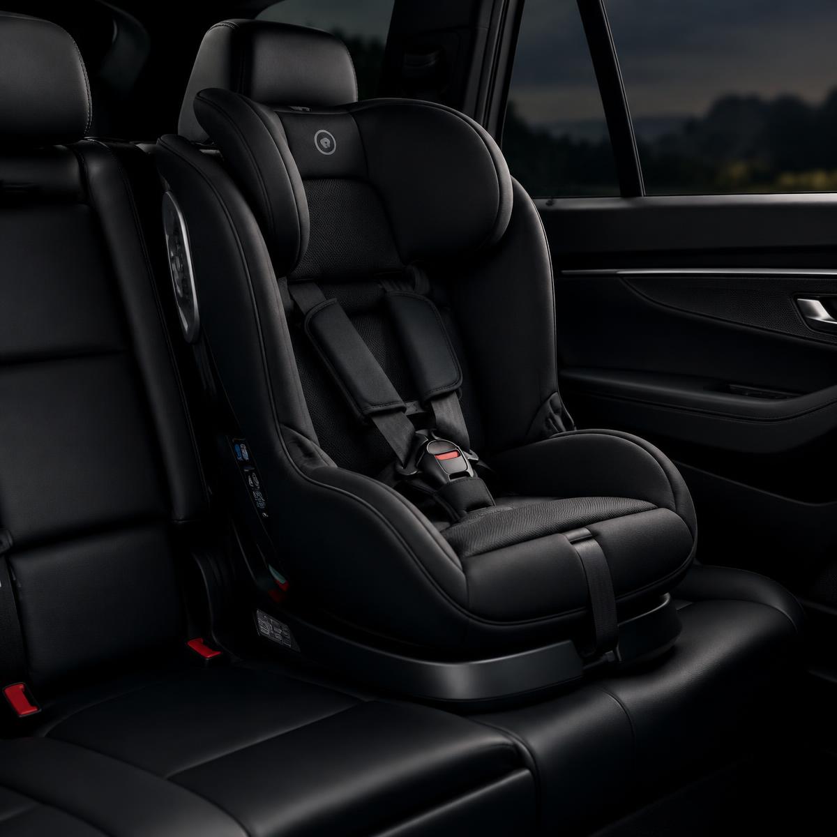 Clean child car seat in a spotless leather back seat